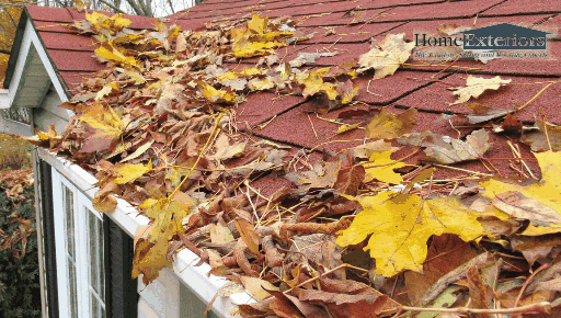 Leaves Clog a Roof Gutter, Showing the Need for Seasonal Maintenance in the Akron & Cleveland Areas