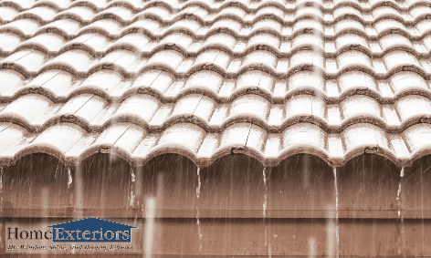 Rainwater Flows Off Roof Tiles in the Akron and Cleveland Areas, Highlighting Maintenance Needs