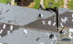 A Team of Roofing Contractors Is Installing Shingles on the Roof of a House in Parma, OH