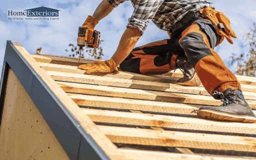 A Worker Skillfully Uses a Drill to Secure Wooden Boards on a Residential Roof in Northfield, OH