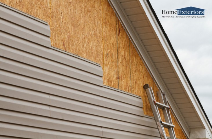 New Vinyl Siding Is Being Installed on a Home with Exposed Wall Sheathing in Northfield, OH