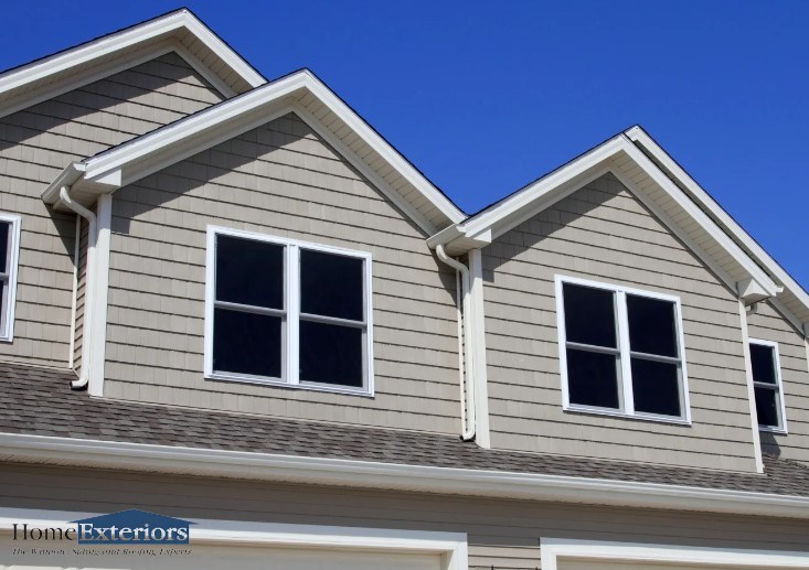 A House with Newly Replaced Vinyl Siding, White Trim, and Matching Gutters in Northfield, OH