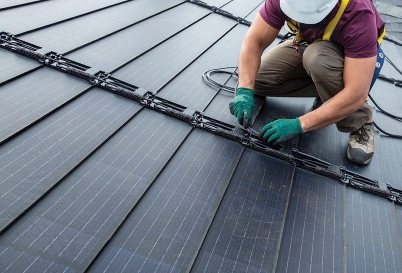 Technician Removing and Reinstalling Rooftop Solar Panels During a Roof Replacement in Cleveland, OH