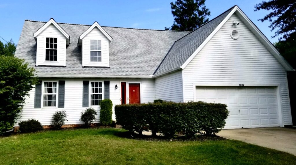 Residential home with asphalt shingle roof and dormer windows in Northfield, OH